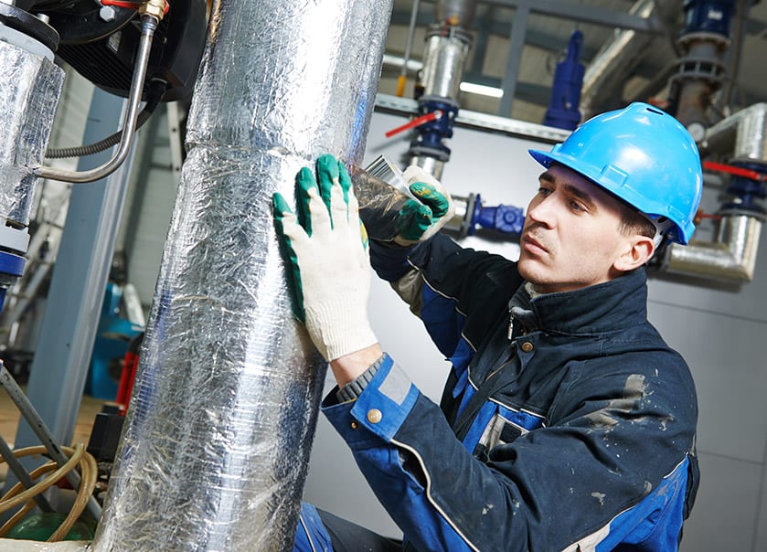 insulation worker installing pre-insulated pipework