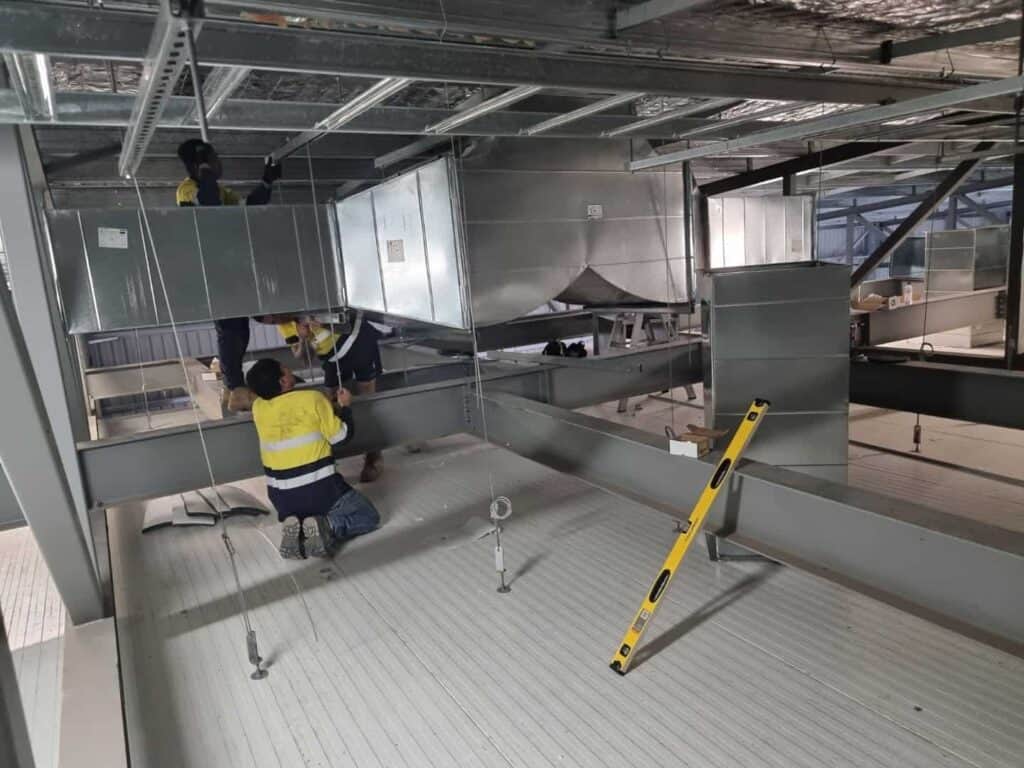 workers spraying passive fire spray to enhance building fire protection