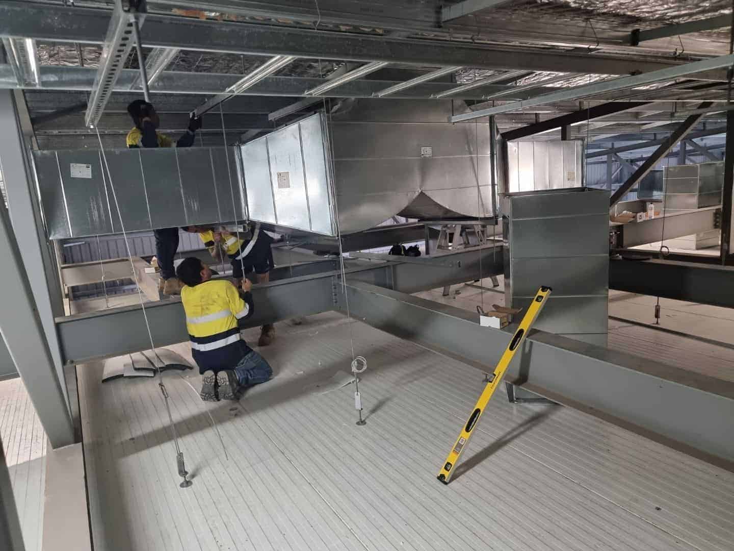 workers spraying passive fire spray to enhance building fire protection