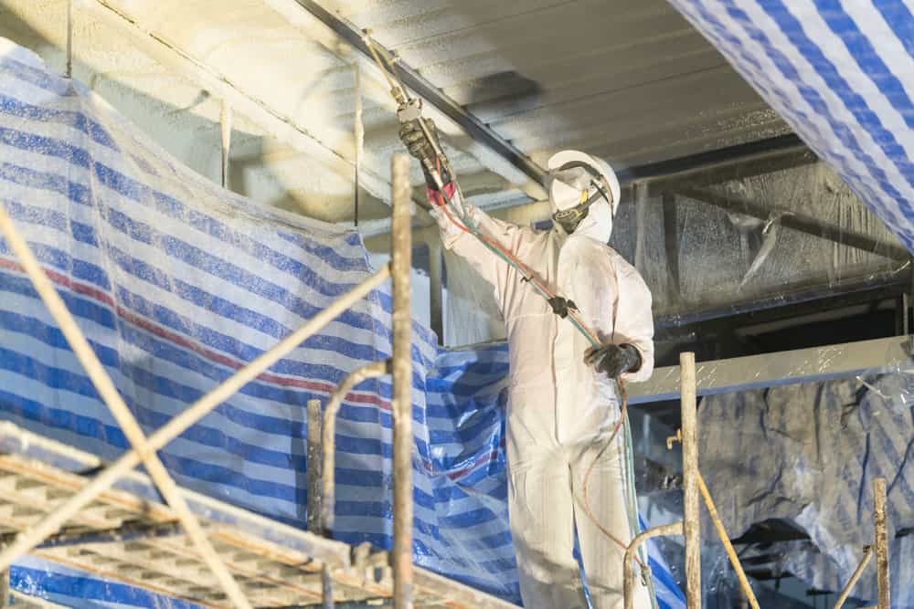 Technician spraying foam